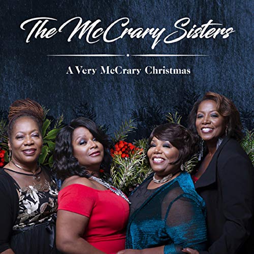 "CD cover featuring four women in formal attire with festive greenery behind them."