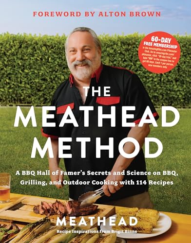 Book with BBQ recipes, photos, and grilling techniques on a rustic outdoor cooking background.