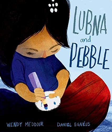 A girl with long dark hair holds a small white pebble and a marker.