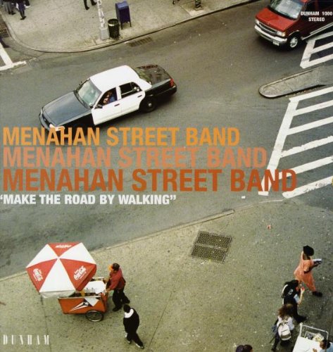 Vinyl record cover: street scene with cars, pedestrians, and band name.