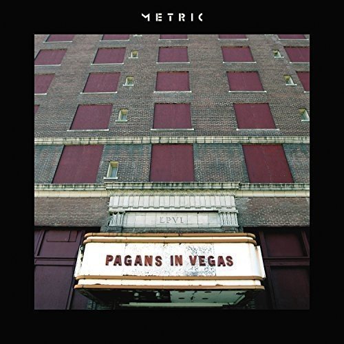 Album cover for Metric’s “Pagans In Vegas” featuring a brick building facade.