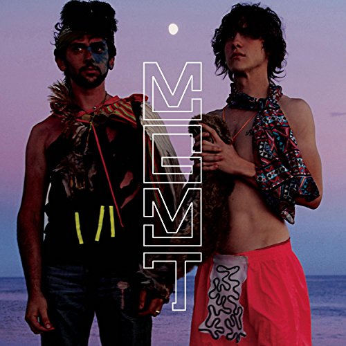 Two men in eccentric clothing stand on a beach at dusk with MGMT text overlay.
