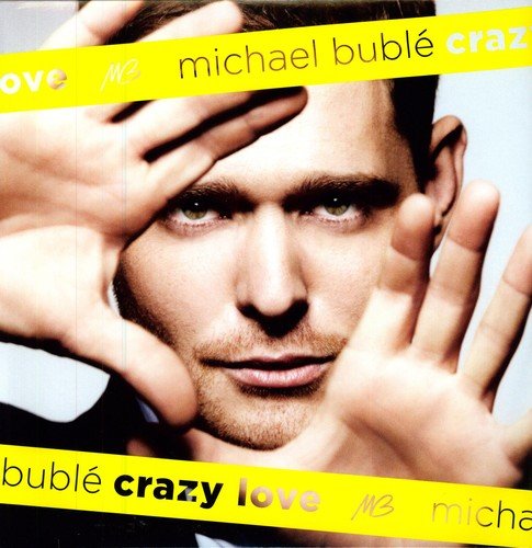 Close-up portrait of Michael Bublé with hands framing his face, overlaid by yellow bands.