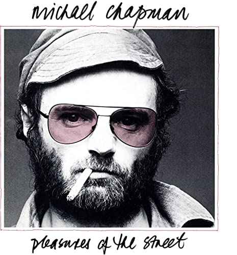 Black and white portrait of Michael Chapman with cap and sunglasses.