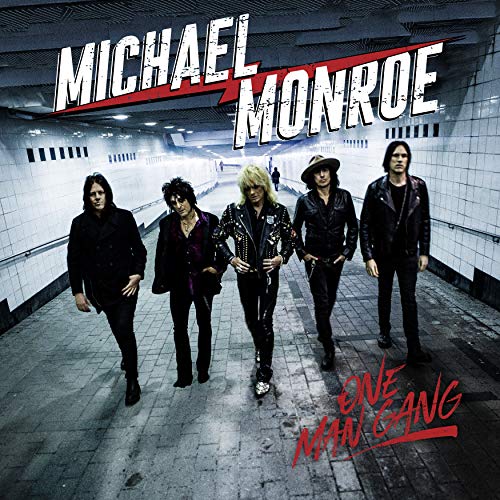 Michael Monroe and band members posing in a subway tunnel.