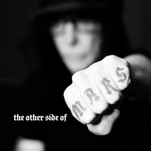 Vinyl record sleeve with Mick Mars' name and album title on a black background.