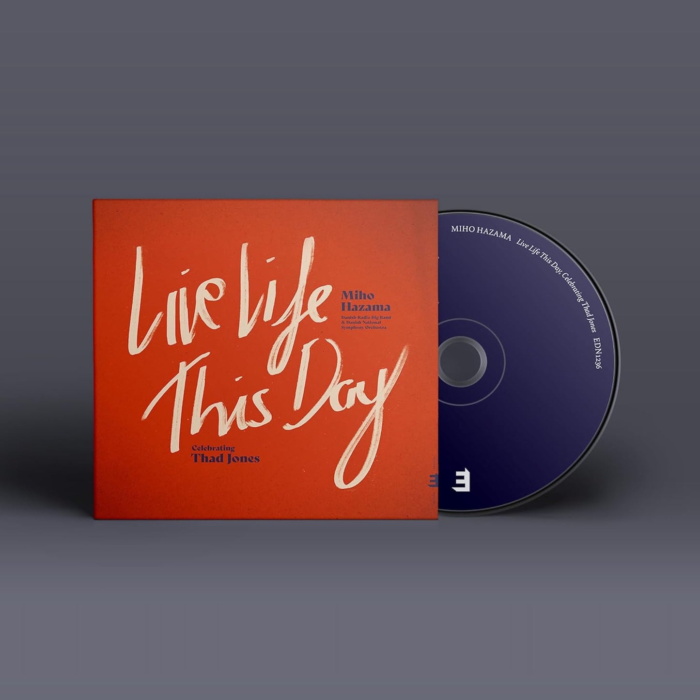 CD case with red and white text, featuring “Live Life This Day.”