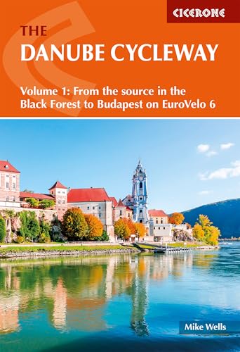 Book cover featuring a riverside town with a church and mountains.