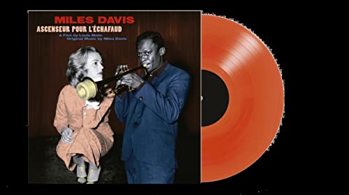 Miles Davis album cover and orange vinyl record against black background.