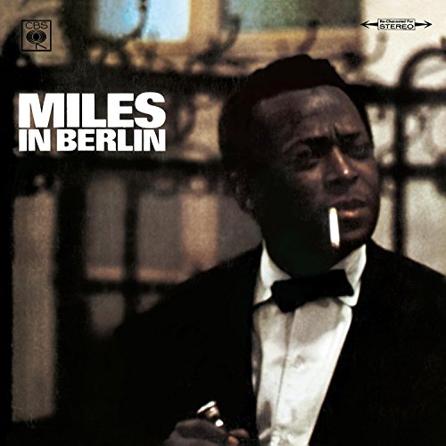 Miles Davis in a tuxedo with a cigarette, album cover for Miles in Berlin.
