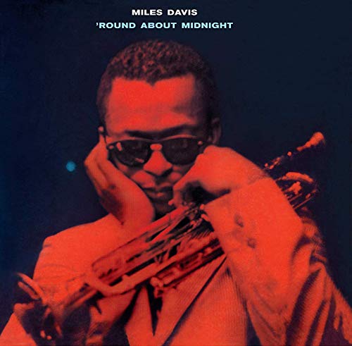 Miles Davis with trumpet, album cover in red and dark blue tones.