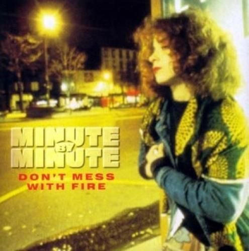CD cover: woman with curly hair on a city street at night.