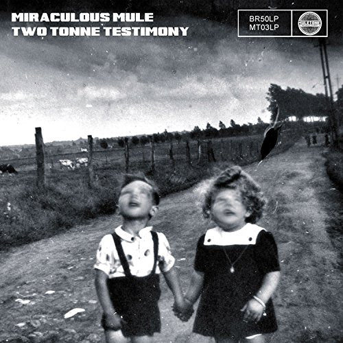 Black and white photo of two children holding hands, looking upwards.