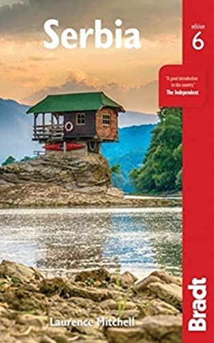 Cover of “Serbia” Bradt Travel Guide, featuring a lakeside wooden cabin.