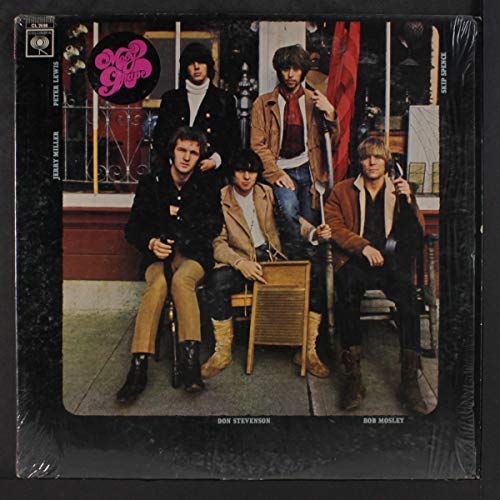 Vinyl record cover featuring five men posing outdoors in 1960s style clothing.