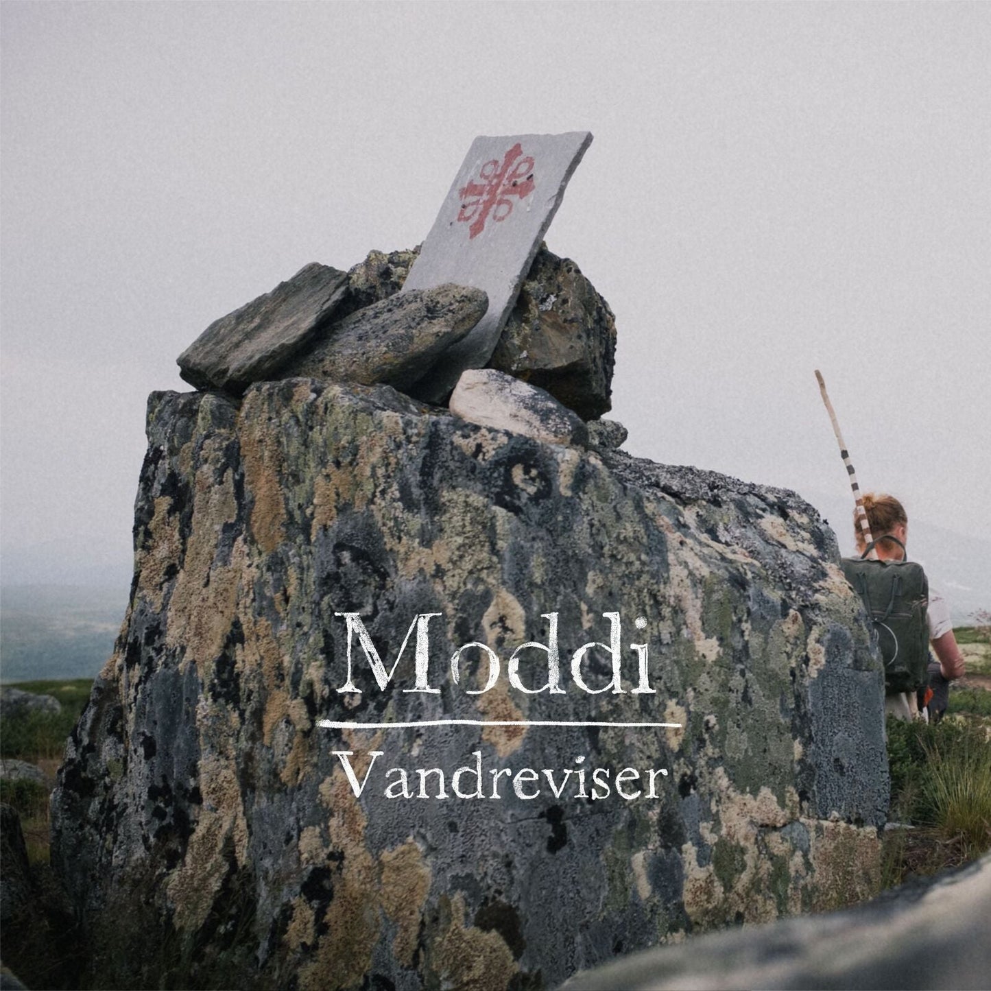 Album cover for Moddi’s “Vandreviser” featuring a rocky landscape.