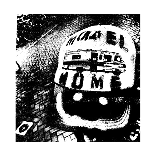 Black and white album cover with a van and text on a face.