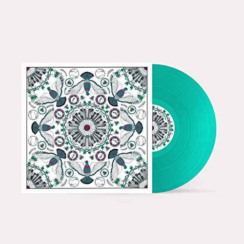 The image depicts a vinyl record and its cover. #### Alt text: "Teal vinyl record with ornate white and black patterned cover."