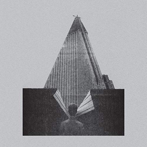 Black and white album cover featuring a building and a person’s back.