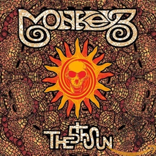 Monkey3 album cover: skull within a sun on patterned background.