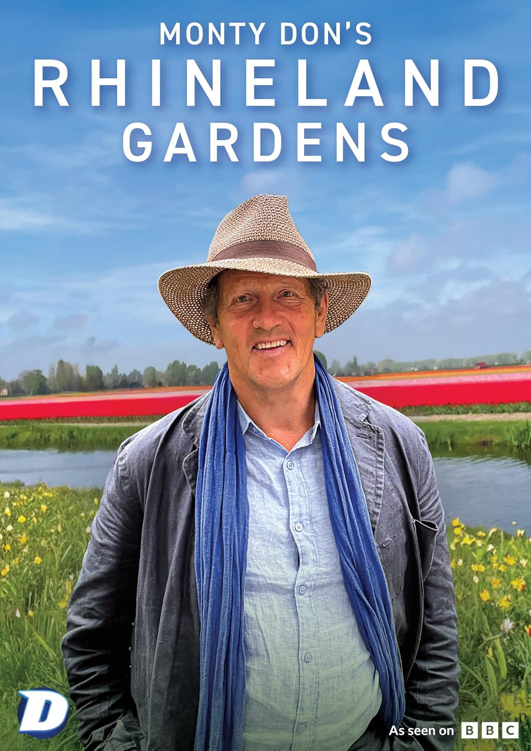 Monty Don in a straw hat, standing in a colorful garden.