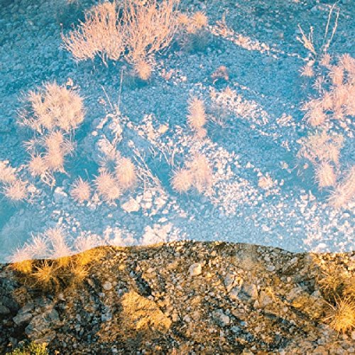 Vinyl record cover with abstract blue and beige landscape reflection.