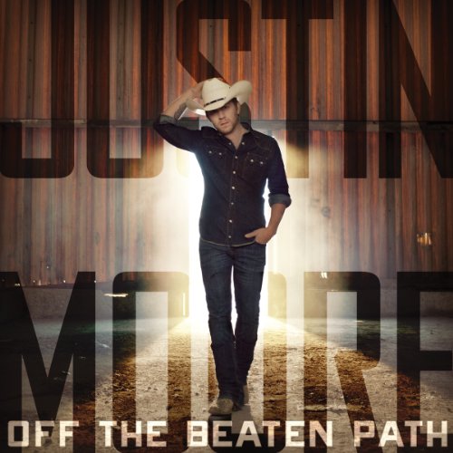 Justin Moore album cover featuring a country singer in a cowboy hat.