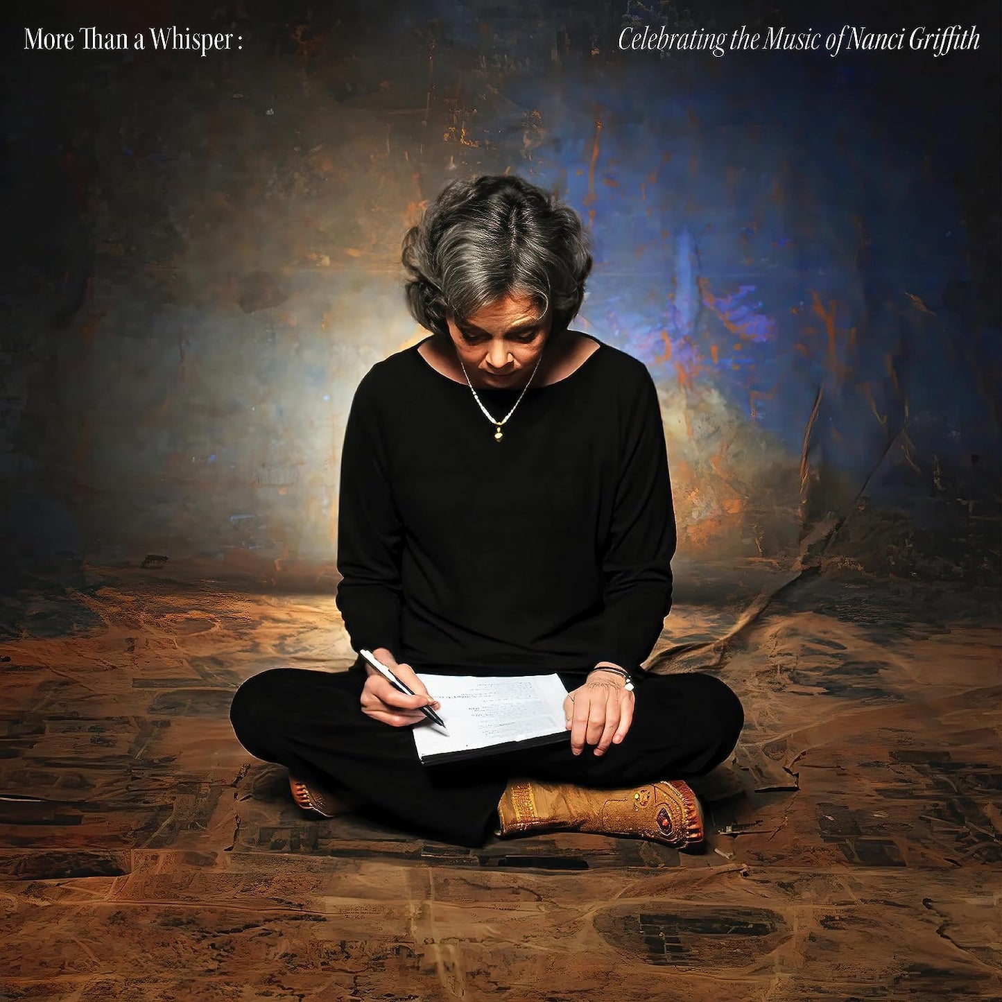 Nanci Griffith portrait, seated and writing on a textured background.