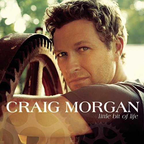 Craig Morgan leaning against a large metal gear on his album cover Little Bit Life.