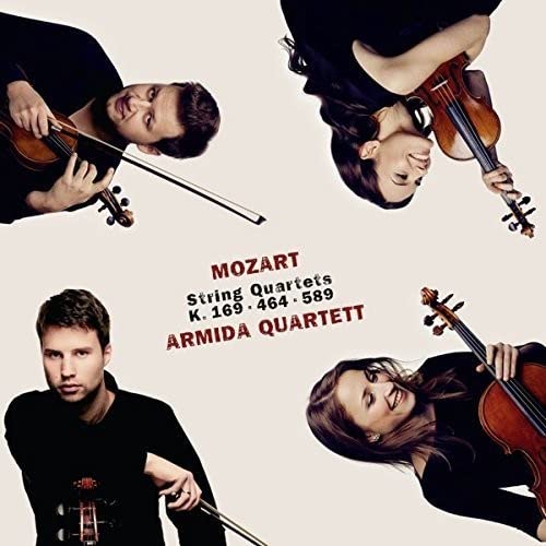 Four musicians playing string instruments, album cover for Mozart quartets.