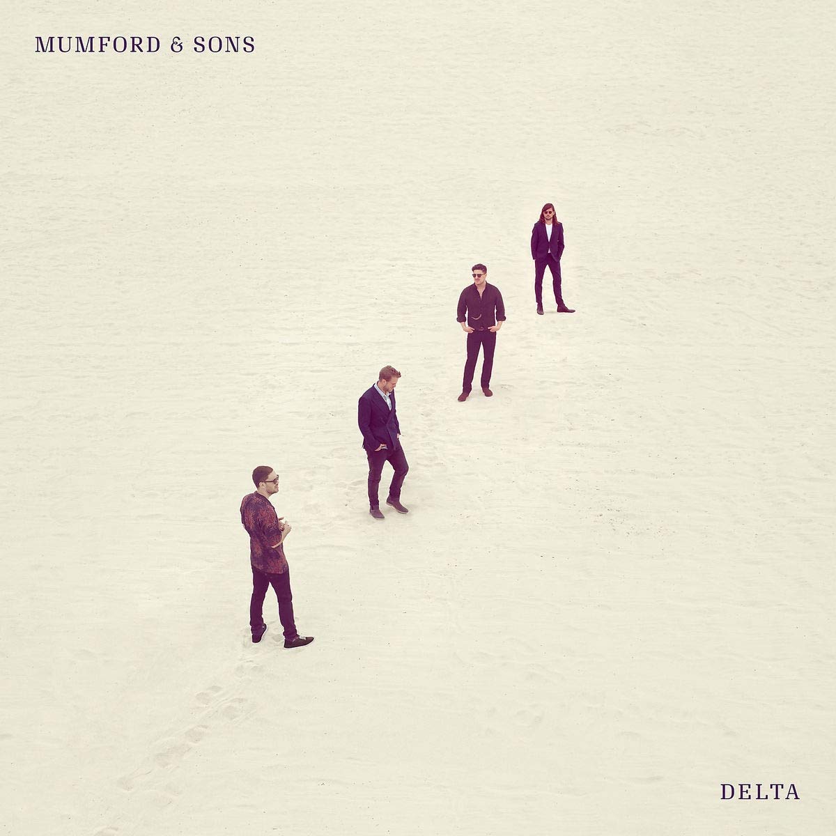 "CD cover with four men in suits standing on beige sand, 'Mumford & Sons Delta'."