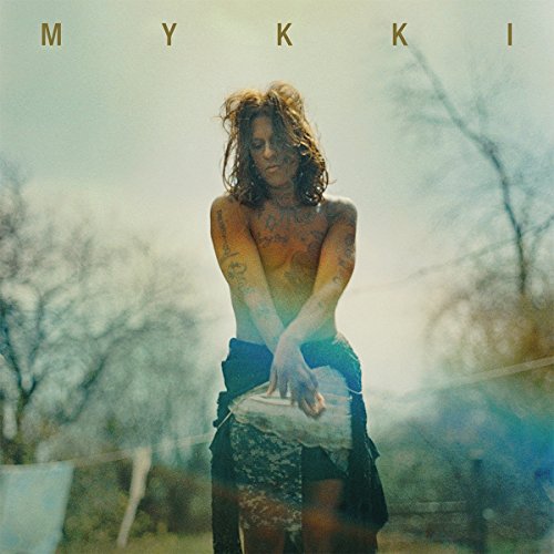 Album cover for Mykki Blanco’s “MYKKI” featuring a torso portrait in nature.