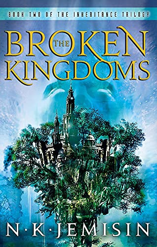 Book cover for The Broken Kingdoms featuring a castle nestled in trees, blue background.