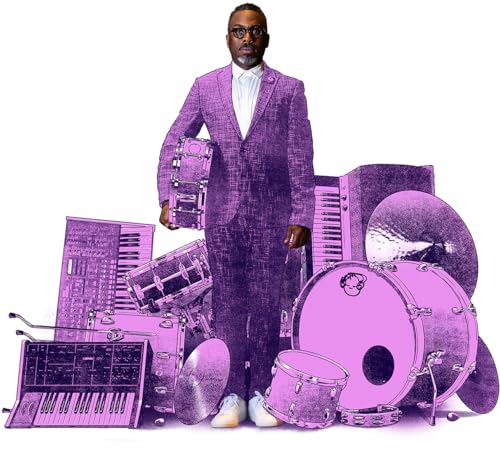 Nate Smith in purple suit surrounded by vintage musical instruments.
