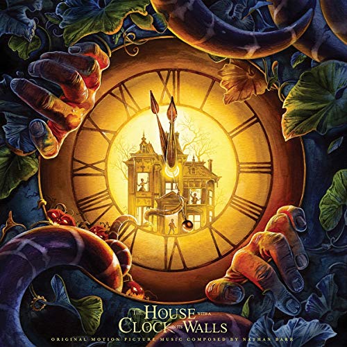 A large clock face featuring a house inside, surrounded by hands and dark foliage.