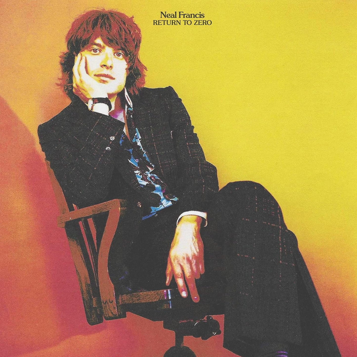 Album cover: Neal Francis portrait in a dark suit, seated in a chair.
