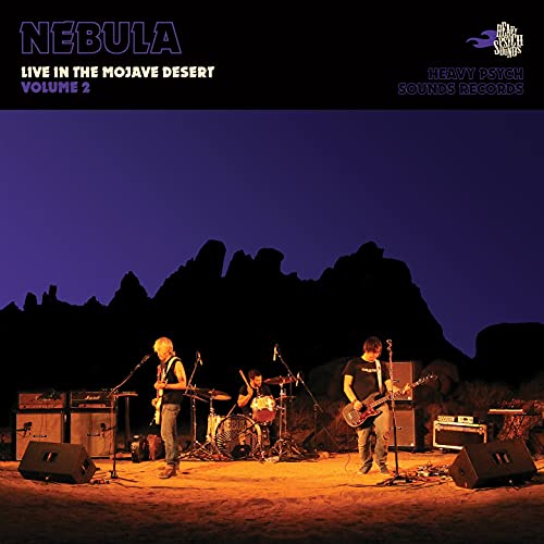 CD cover: band performing outdoors against a desert and sky backdrop.