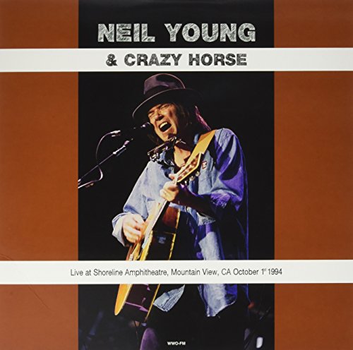 Neil Young playing guitar on stage, album cover for a live recording.