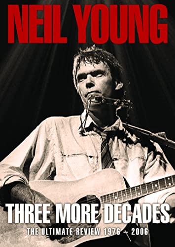 Neil Young playing acoustic guitar on DVD cover, black and white.