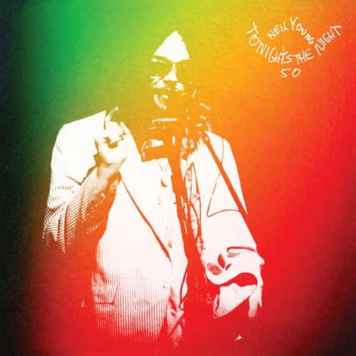 Neil Young album cover: a performer in a suit, red and green hues.