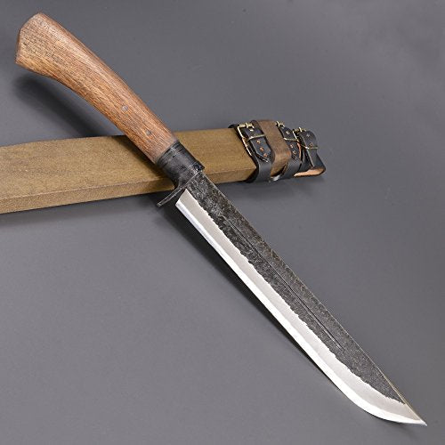 Large knife with wooden handle and sheath, lying on a gray surface.