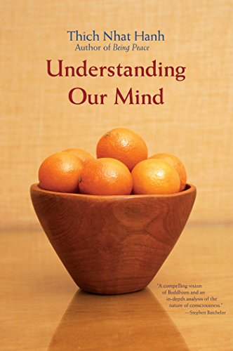 Book cover: "Understanding Our Mind" by Thich Nhat Hanh with oranges.
