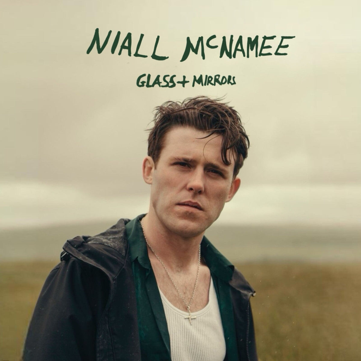 Album cover for Niall McNamee’s “Glass and Mirrors” featuring a portrait of the artist.
