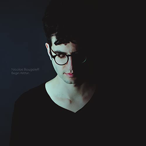 Portrait of a man with glasses, dark background, album cover art.