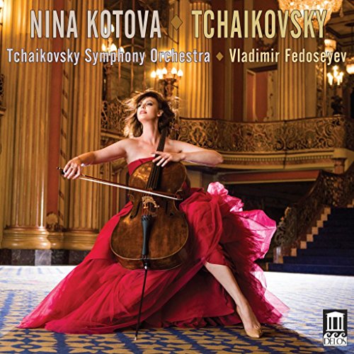A woman in a red dress plays cello on an ornate patterned floor.
