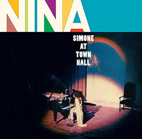 Nina Simone album cover: woman at piano on a stage with spotlight.
