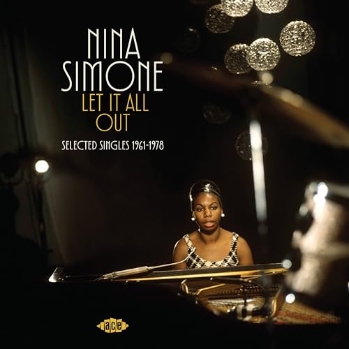 Nina Simone playing piano in a dimly lit room with hanging globe lights.