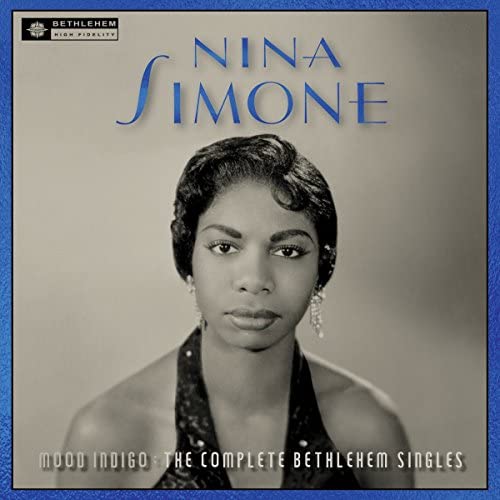 Black and white CD cover featuring Nina Simone with elegant hairstyle and earrings.