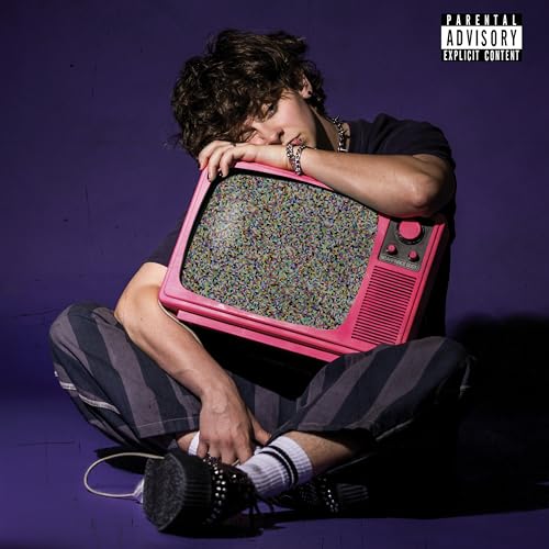 Young man with curly hair hugging a pink, static-filled TV.