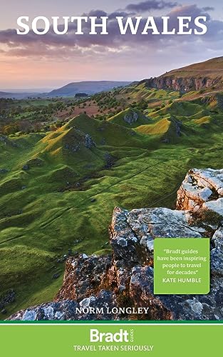 Travel guide cover for South Wales, featuring a hilly landscape.